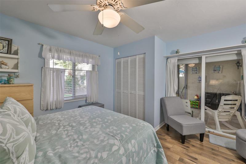Guest bedroom w/sliders to covered seating area and access to courtyard area.