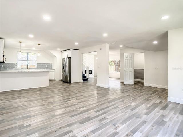 Open Living Room Area to Kitchen, Dining Room, Electric Fireplace and Upstairs Living Area
