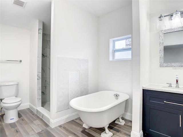 Claw Foot Tub, Separate Shower and Vanity with Granite Countertops