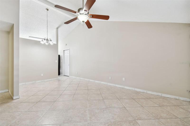 Vaulted ceilings and tile flooring in living area.