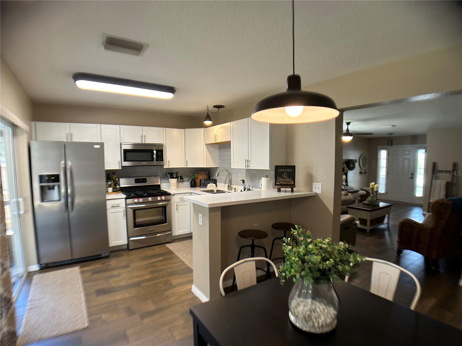 KITCHEN WITH LARGE WINDOW AND SLIDER TO LANAI
