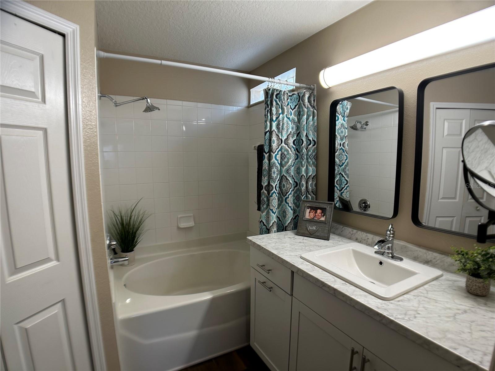 MASTER BATHROOM WITH BUILT IN LAUNDRY BINS