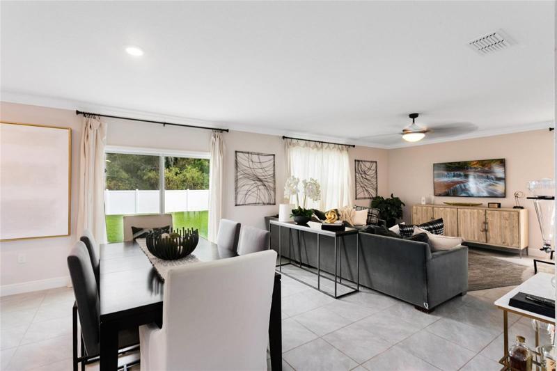 The living room, dining room, and kitchen flow seamlessly in a bright and open floor plan, creating a fantastic space for everyday living and entertaining.
