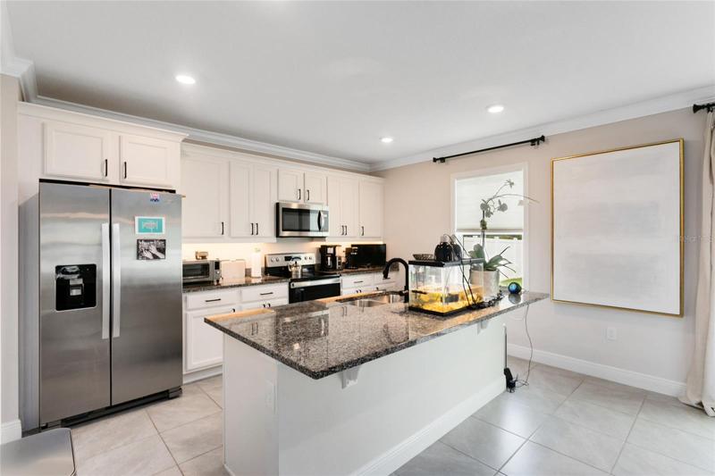 Your well-appointed kitchen boasts STAINLESS STEEL appliances and GRANITE countertops, making it a delight for any chef.