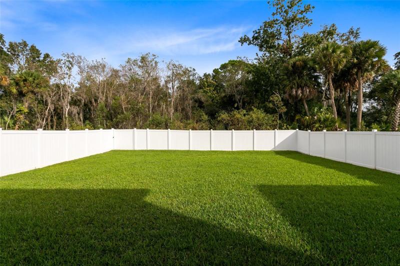A fully fenced backyard backs up to a conservation area, ensuring NO REAR NEIGHBORS and offering a private oasis to relax and unwind.