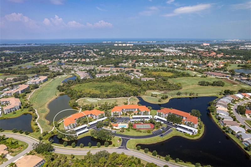 Aerial view of Clubside condo, the golf course.and ponds