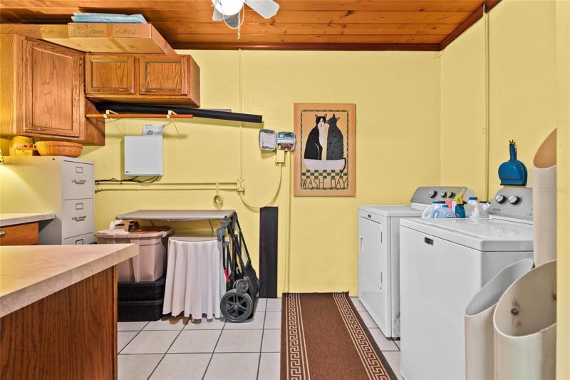 oversized laundry room with additional storage and work space