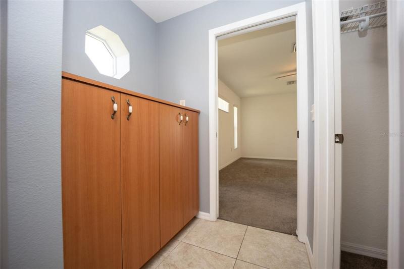 Master bathroom with shelving and linen closet