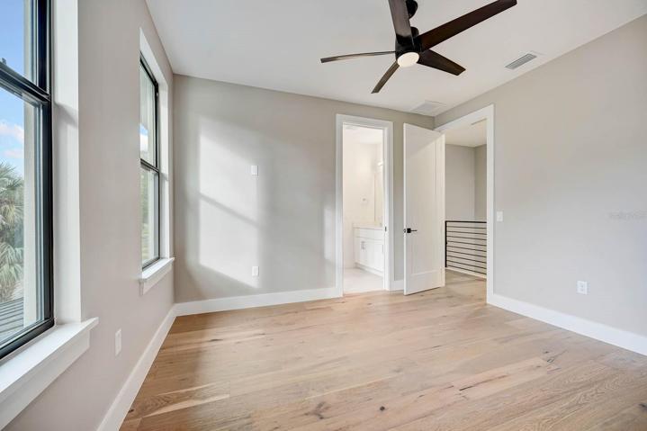 bedroom 3 with wood flooring