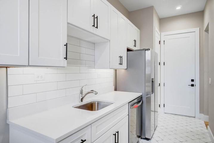 large scullery with second refrigerator dishwasher