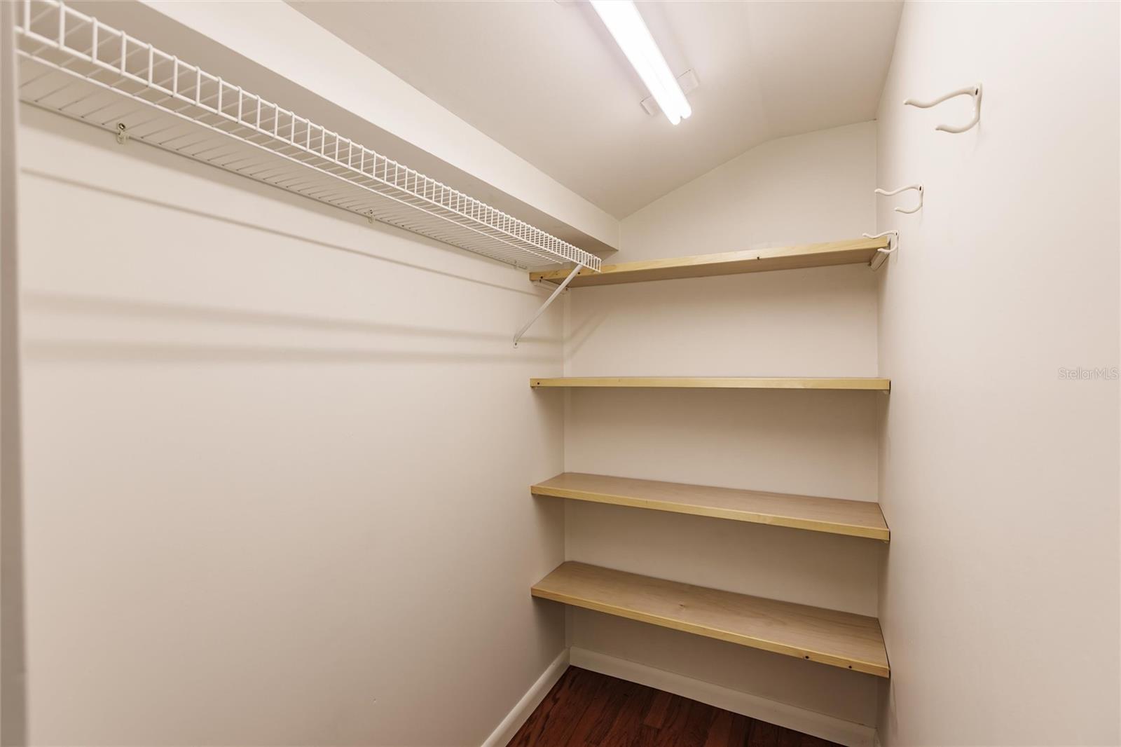 The walk-in closet has built-in shelving to store your belongings.