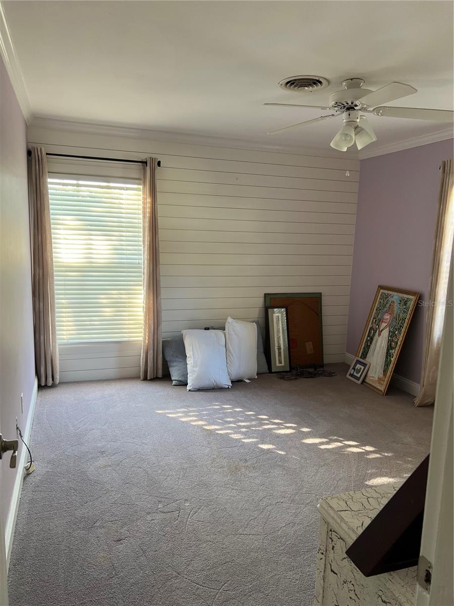 Second bedroom with large windows.
