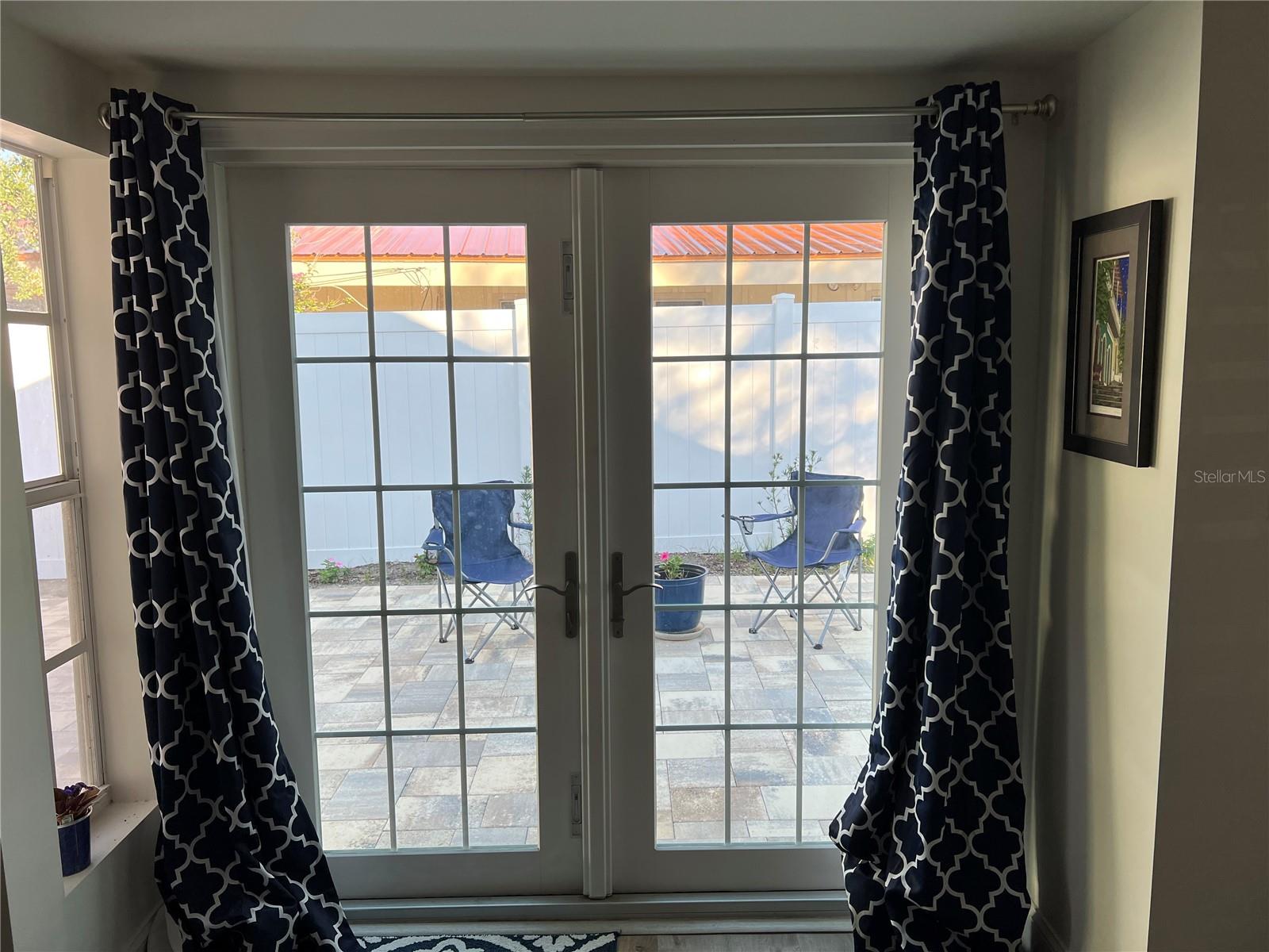French doors off of the dining area lead you to the paved patio.