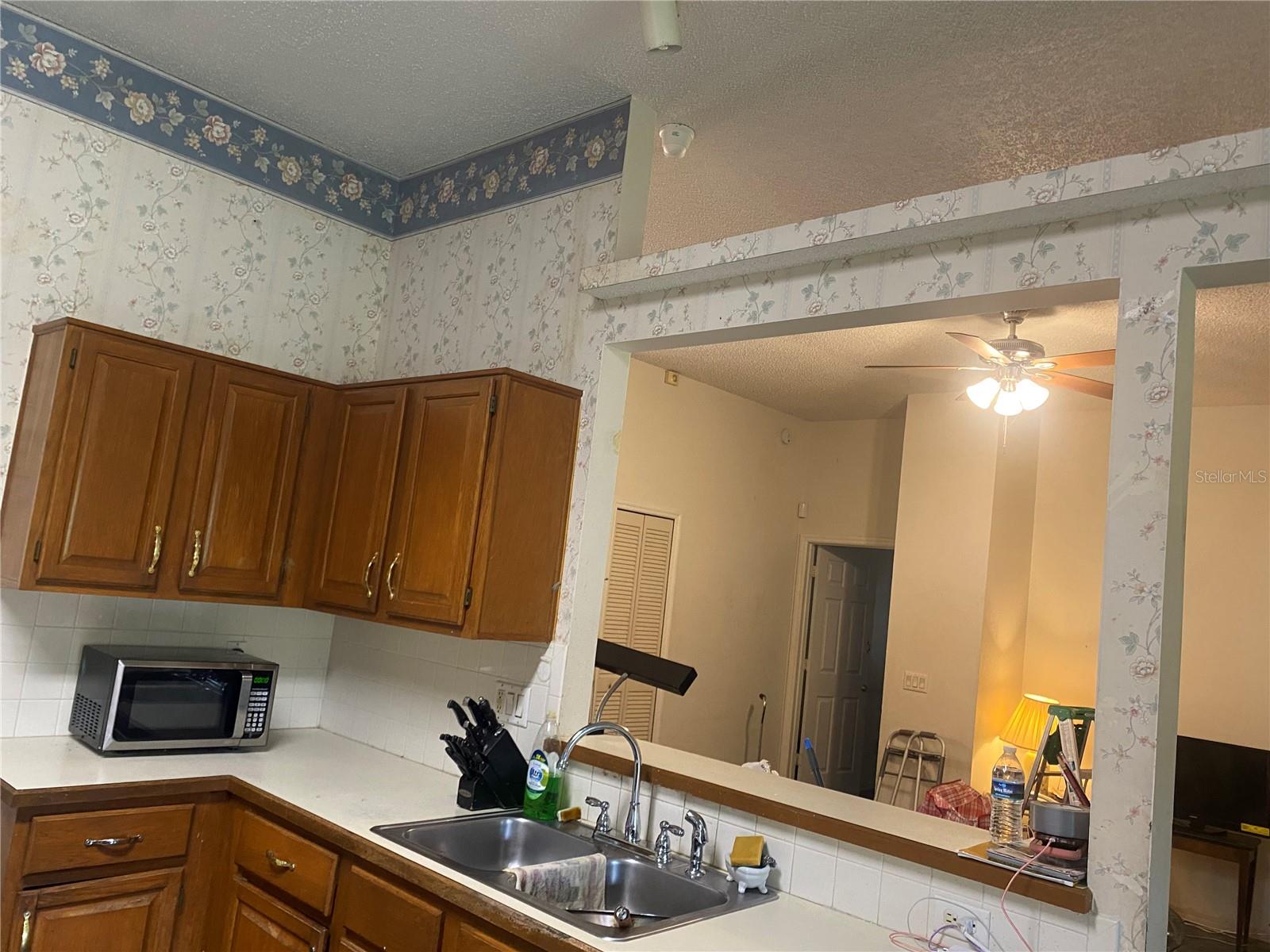 Notice the architectural opening and breakfast bar.