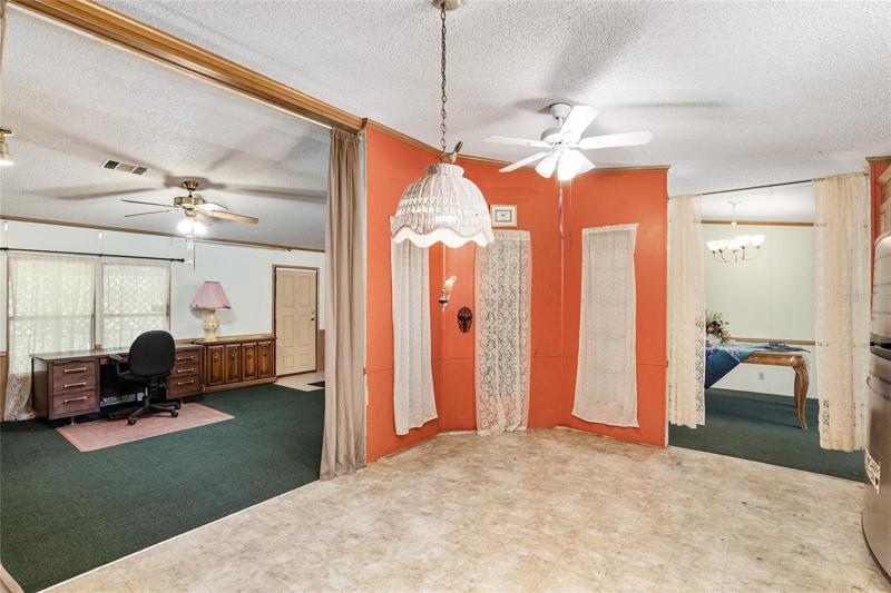 From the kitchen, view of living room on one side, the dining room on the other.