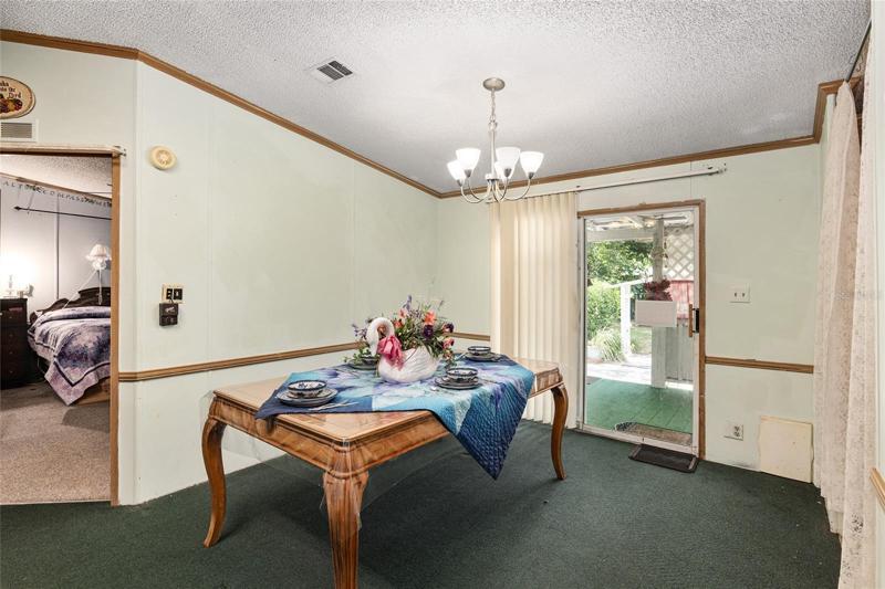 From living room, look at dining room area, main bedroom, and rear patio that leads to the garden.
