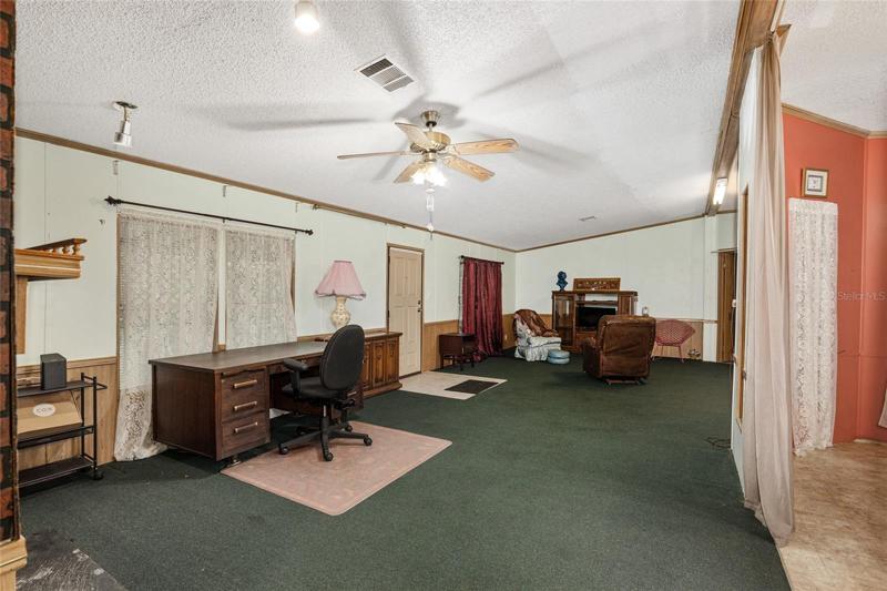 From the fireplace, view of the living room and front door.