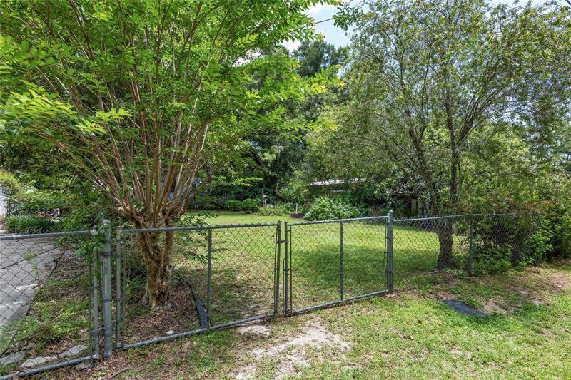 Entrance to garden area from the street. Driveway on the left.