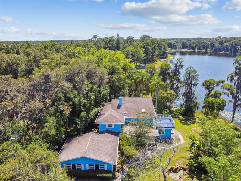 Aerial shot front of home and Rainbow Lake
