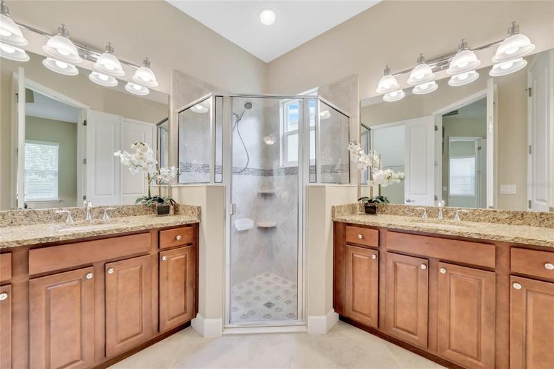 Master Bathroom w/ separate raised height vanities & glass enclosed walk-in shower