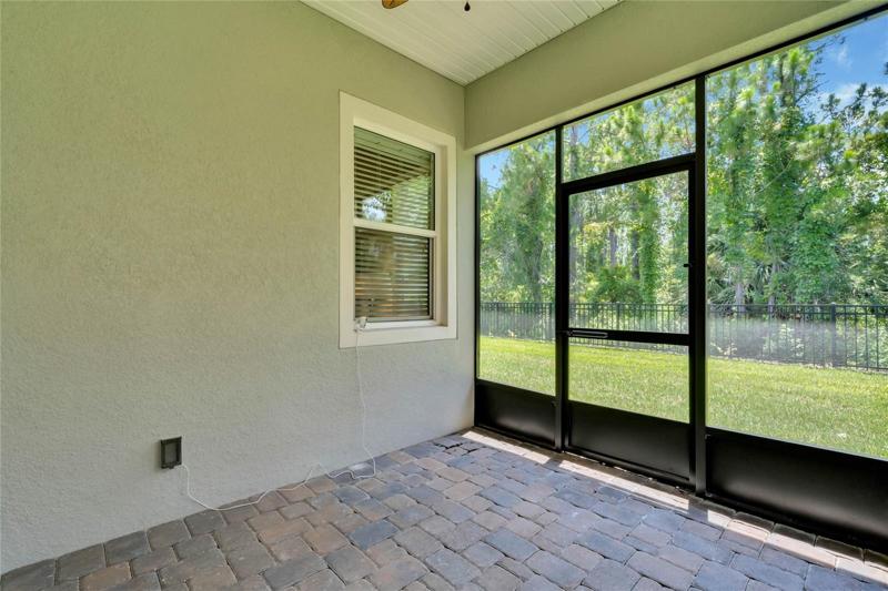 Screen enclosed covered patio w/ a conservation area view