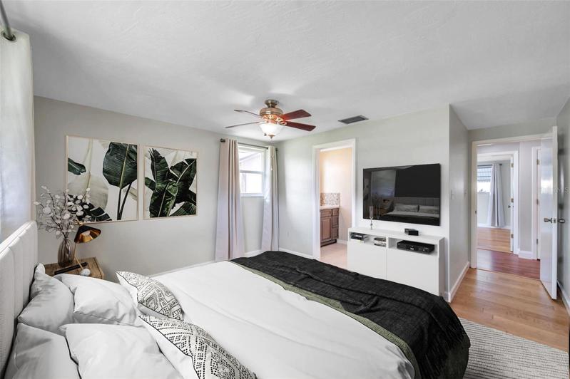 Primary bedroom with full Ensuite Bathroom with large Walk-In Shower, Large Vanity,  lots of natural light, ceiling fan, curtain rods and drapes.