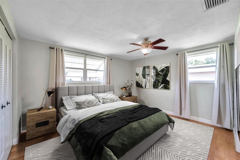 Primary bedroom with full Ensuite Bathroom with large Walk-In Shower, Large Vanity,  lots of natural light, ceiling fan, curtain rods and drapes.