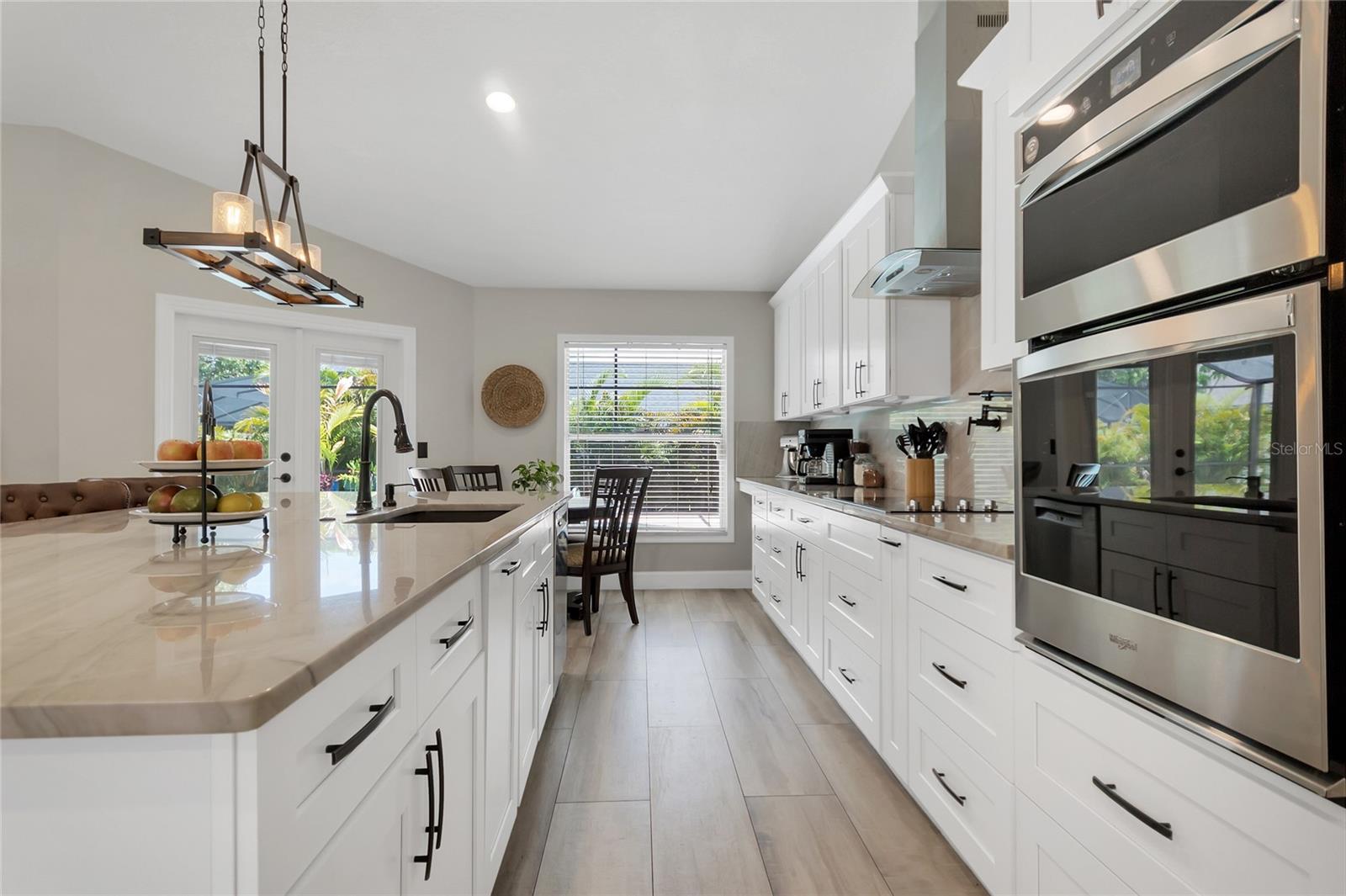 The kitchen, a chef's dream, features ample cabinet and counter space, including built-in pantries.