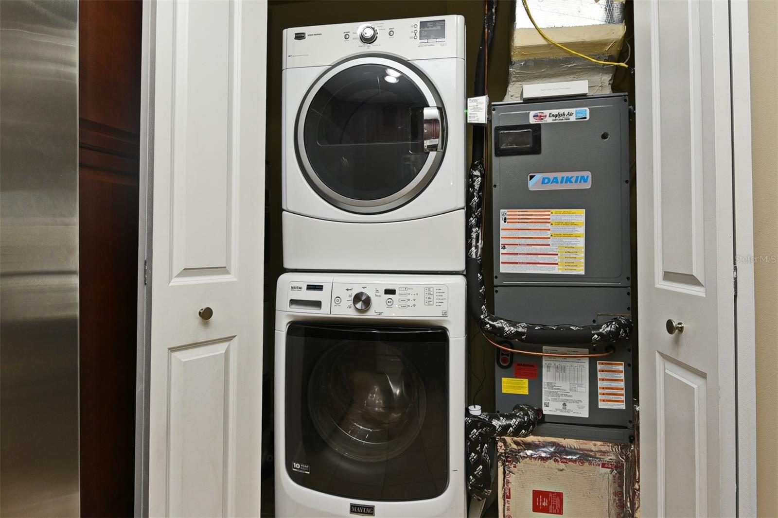 Laundry Closet showing Washer/Dryer and newer Daikin AC