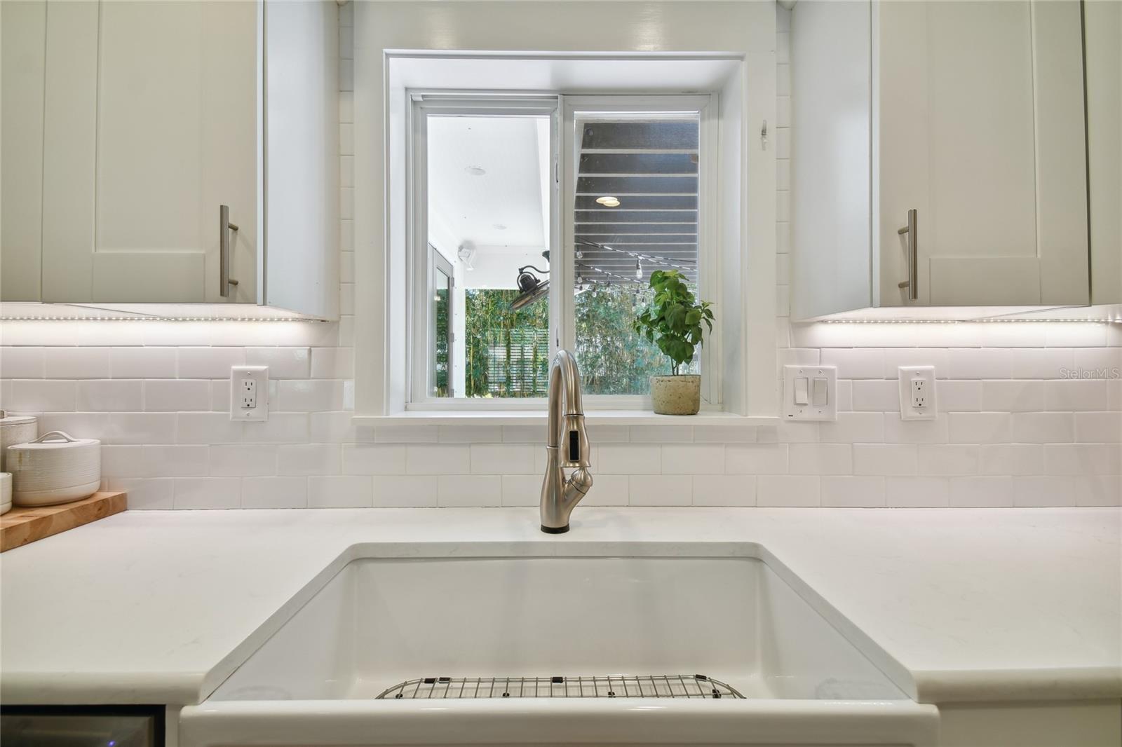 The sink window provides the perfect view of the beautiful backyard and pool.