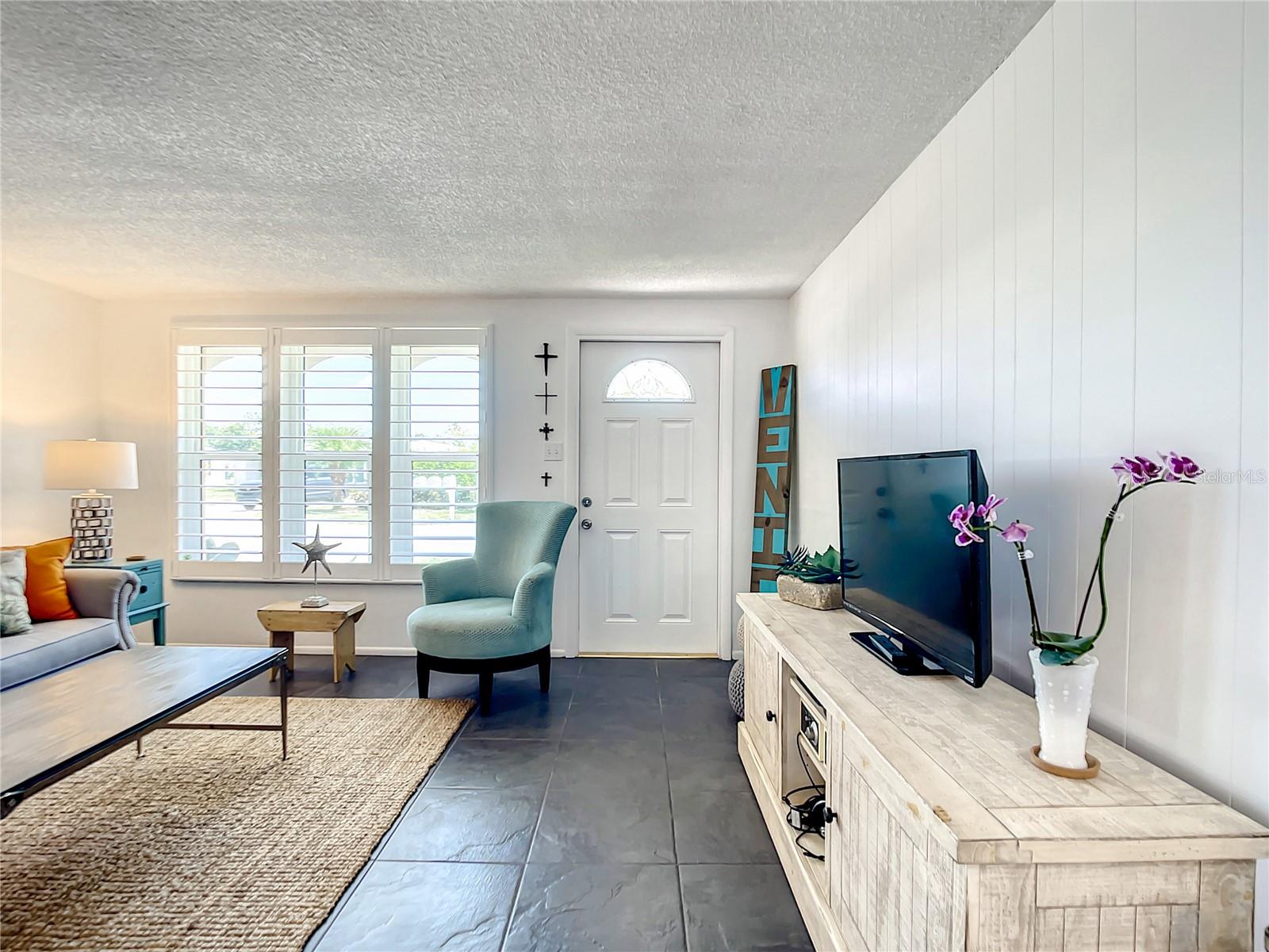 Inside view of the entrance of the home. Note the Plantation Shutters on the Front Window.