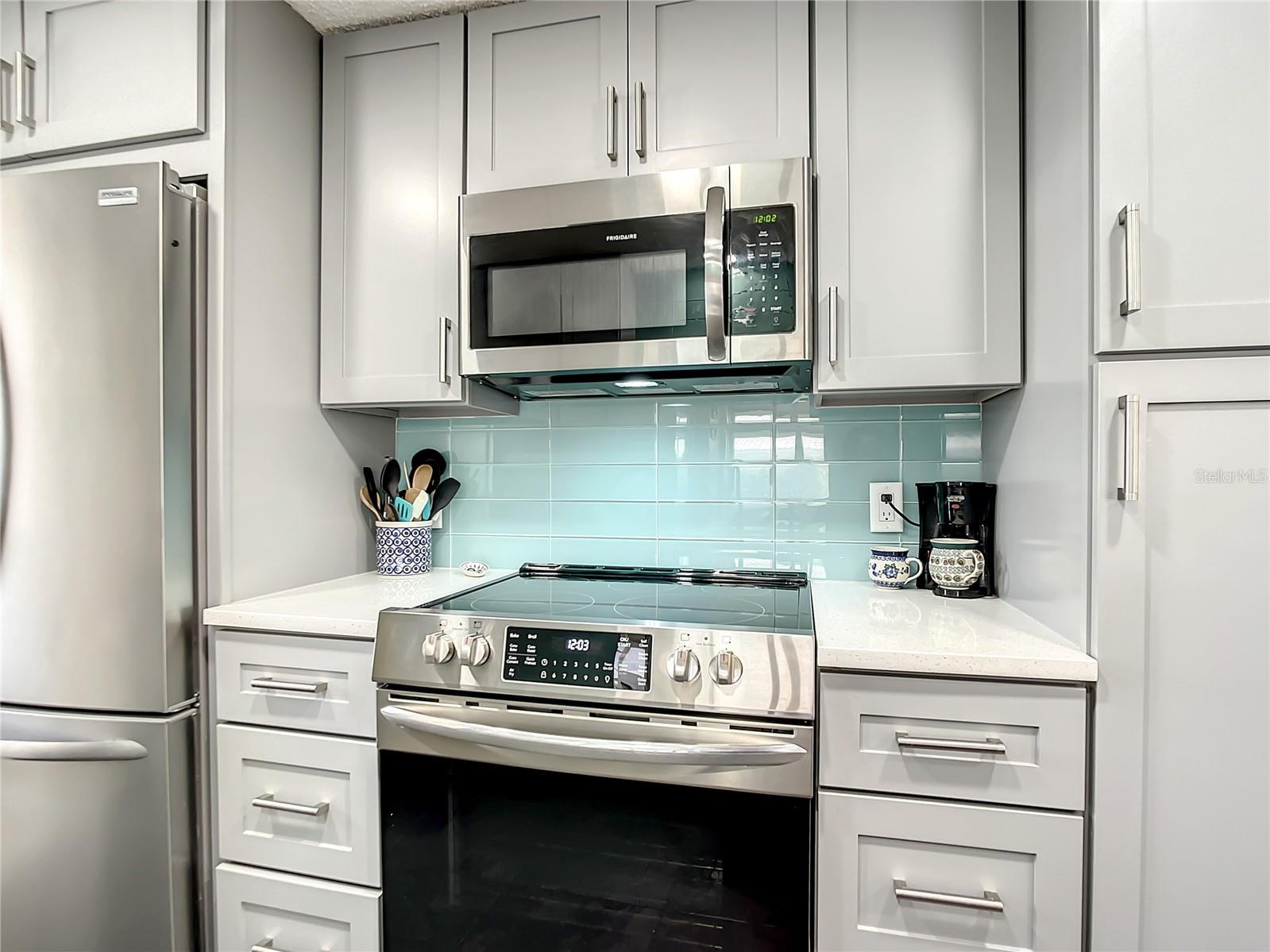 Flat top range and microwave and a closet pantry to the right