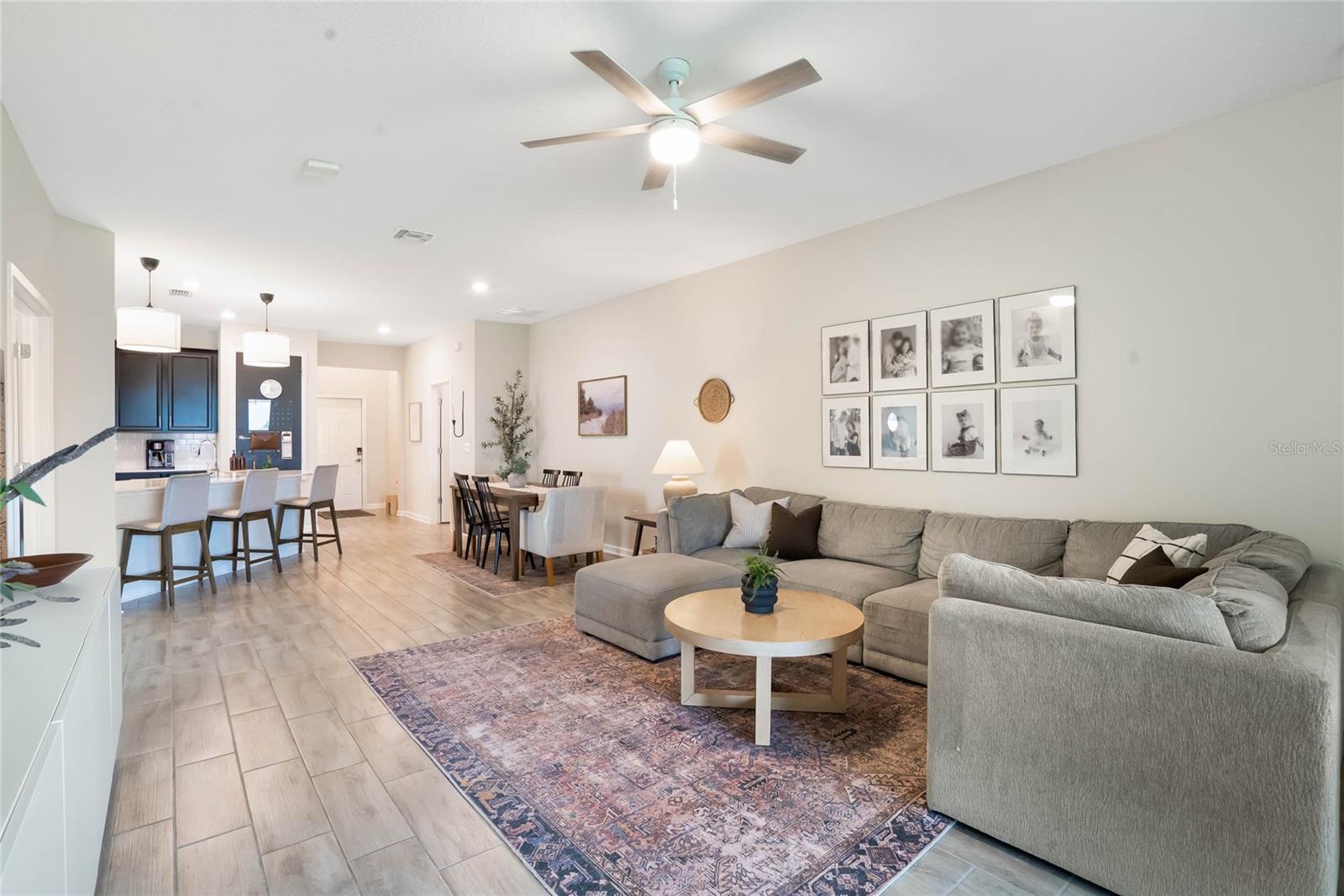 Living room and open concept facing toward front of home. Back patio and master bedroom are behind this image