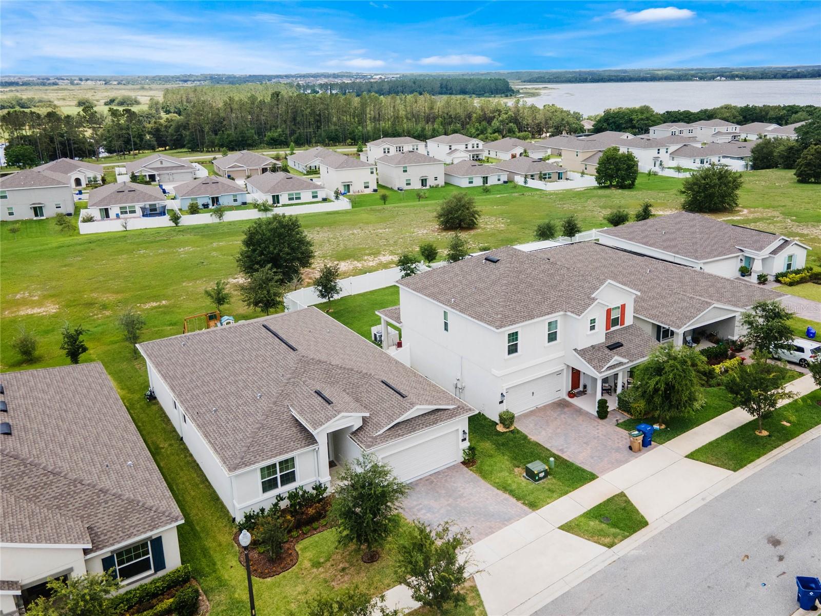 Aerial view of home / community with lake behind