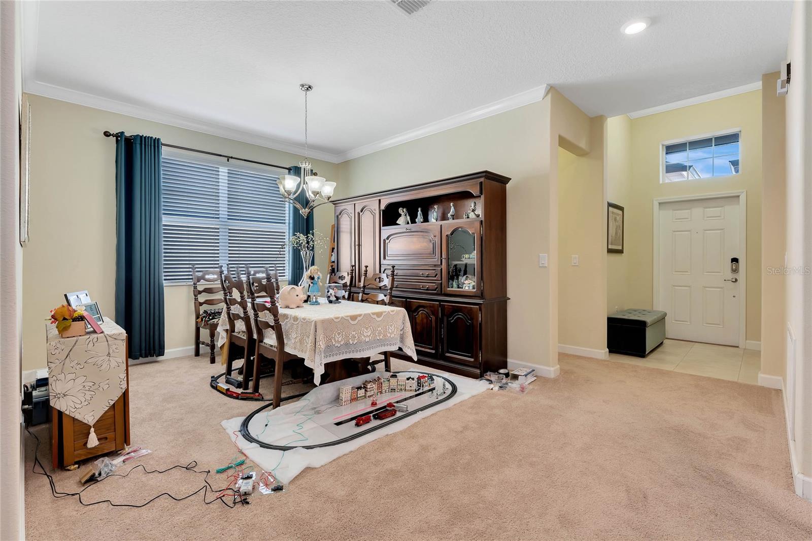Formal Dining Room Offers Crown Molding &amp; Wall to Wall Carpeting