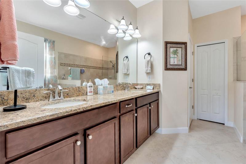 Master Bathroom features a Comfort Height Vanity w/ Dual Sinks & Granite Countertop