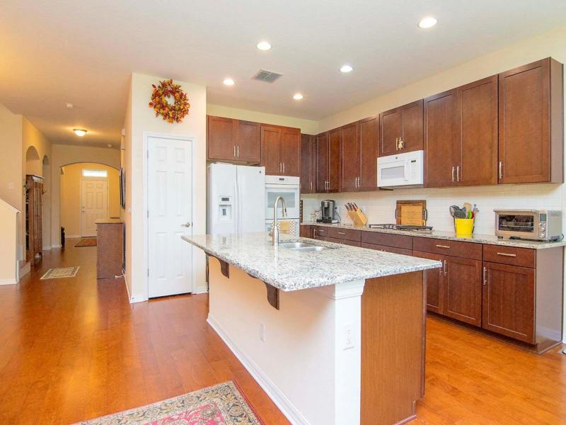 Kitchen with breakfast bar, wood cabinetry, loads of drawers and cabinets