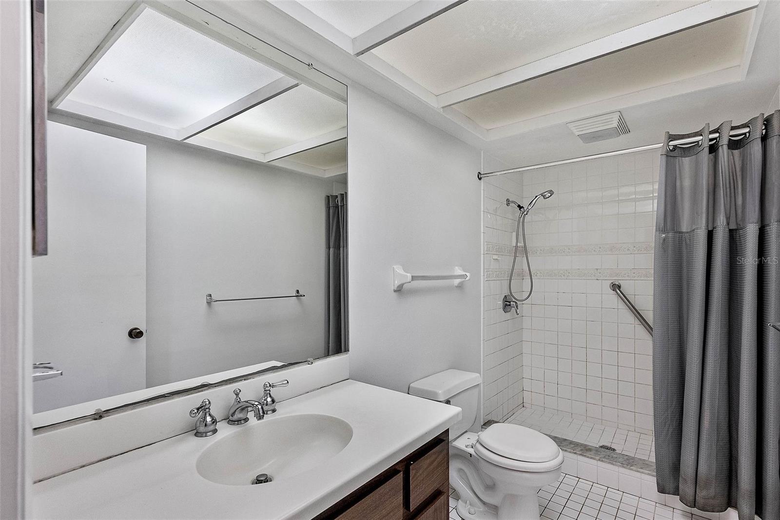 The generously sized bathroom features a walk-in shower.