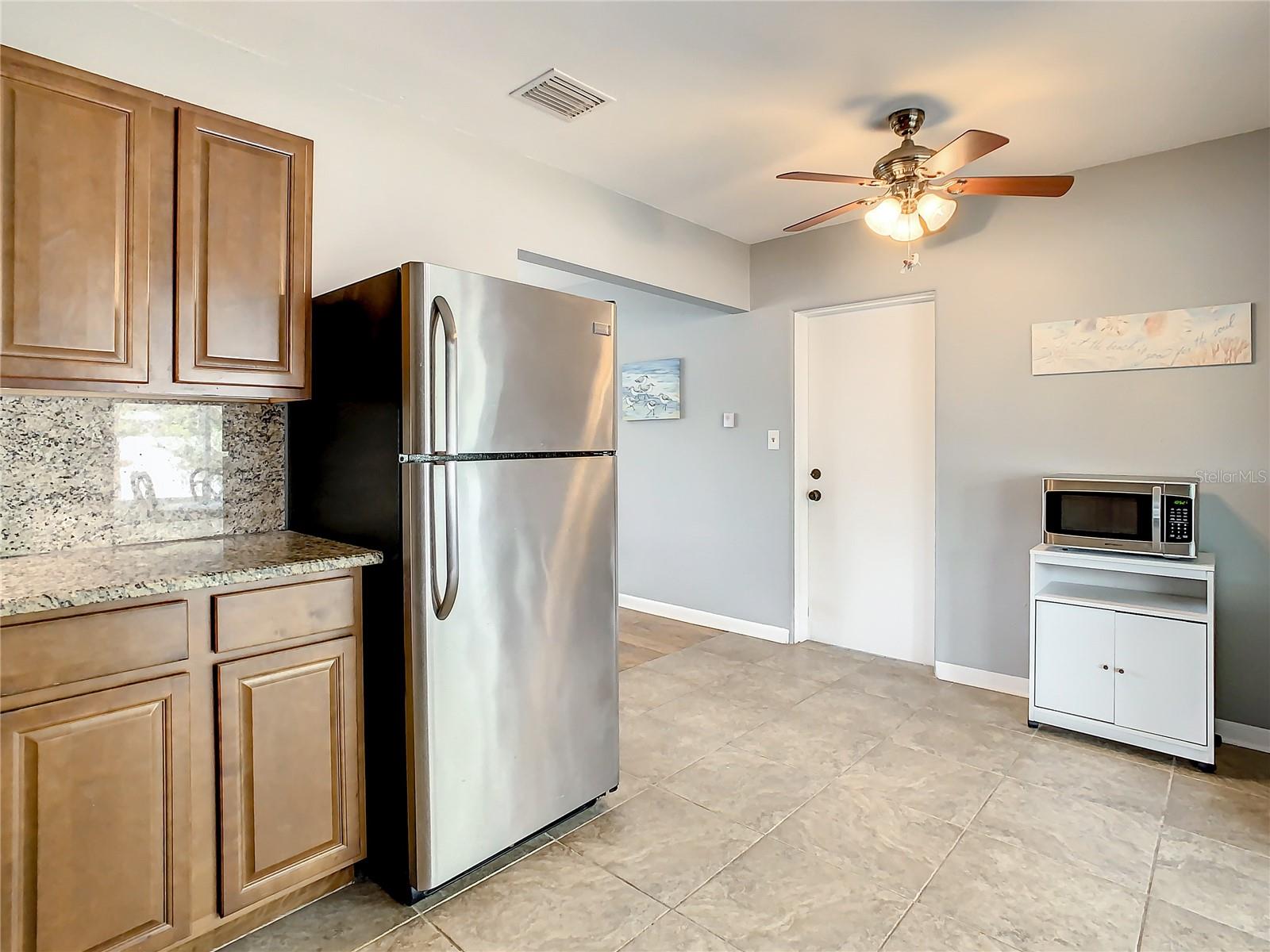Kitchen looking from range towards living area and side door