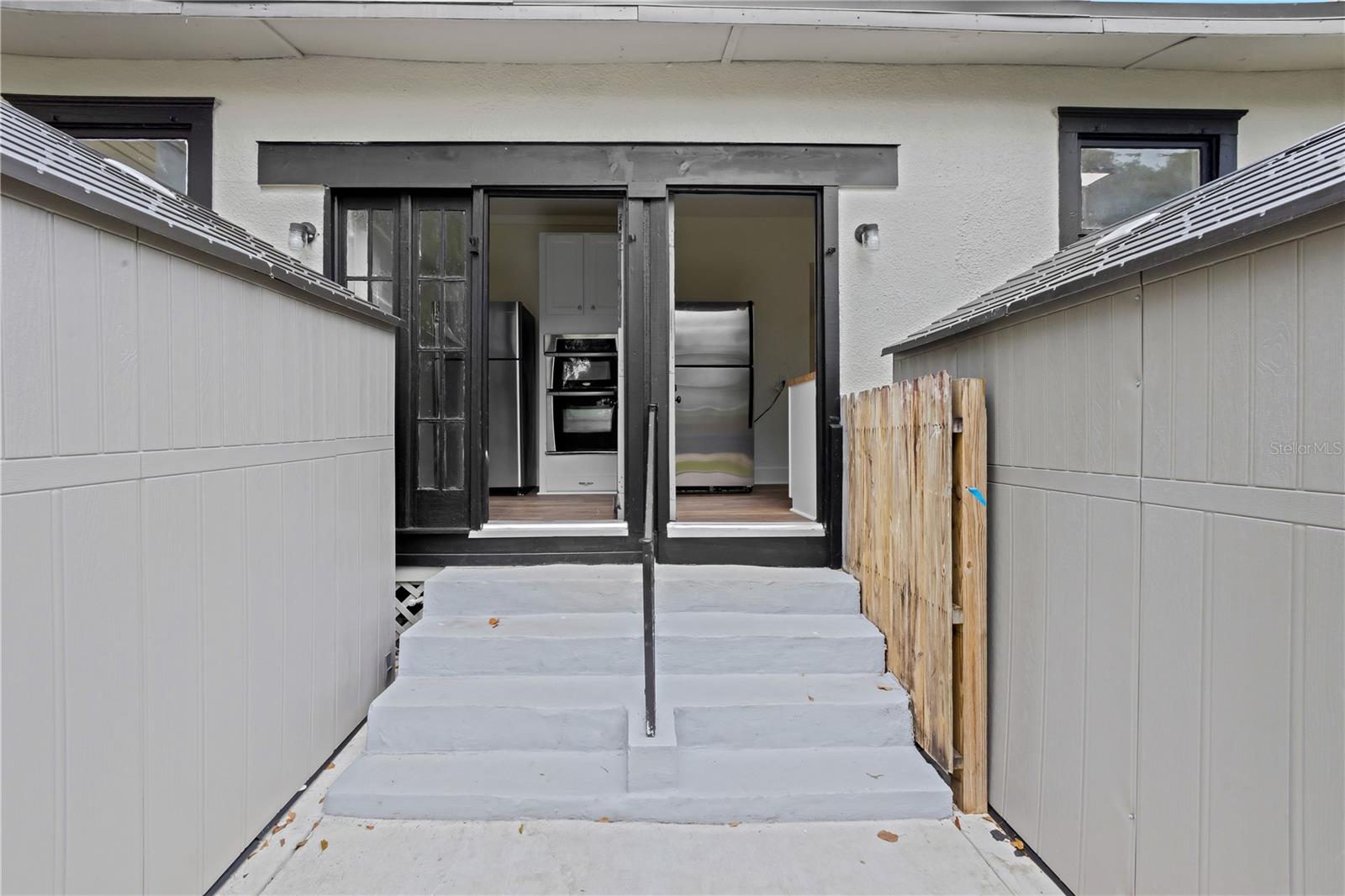 Rear entrance for the units. Each unit has their own laundry shed with hookups.