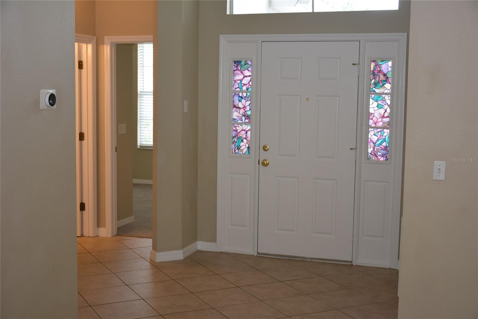 Enter this freshly painted contemporary home from a covered porch, stepping into a dramatic foyer with 12 foot ceilings and palladium window over the front door providing abundant natural light