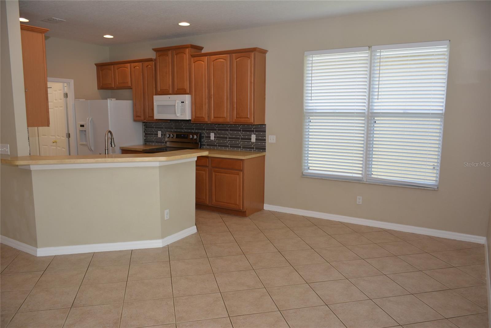 Open floor plan with kitchen overlooking the great room and informal eating area
