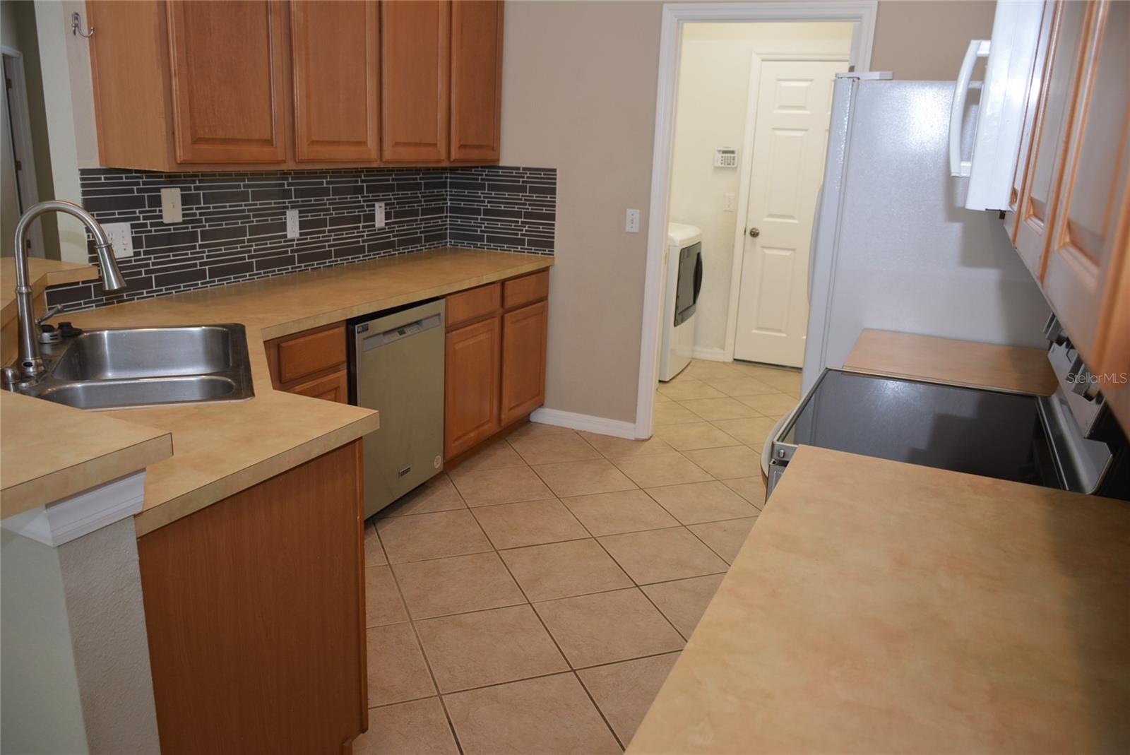 Leading from the kitchen into the laundry room and garage.