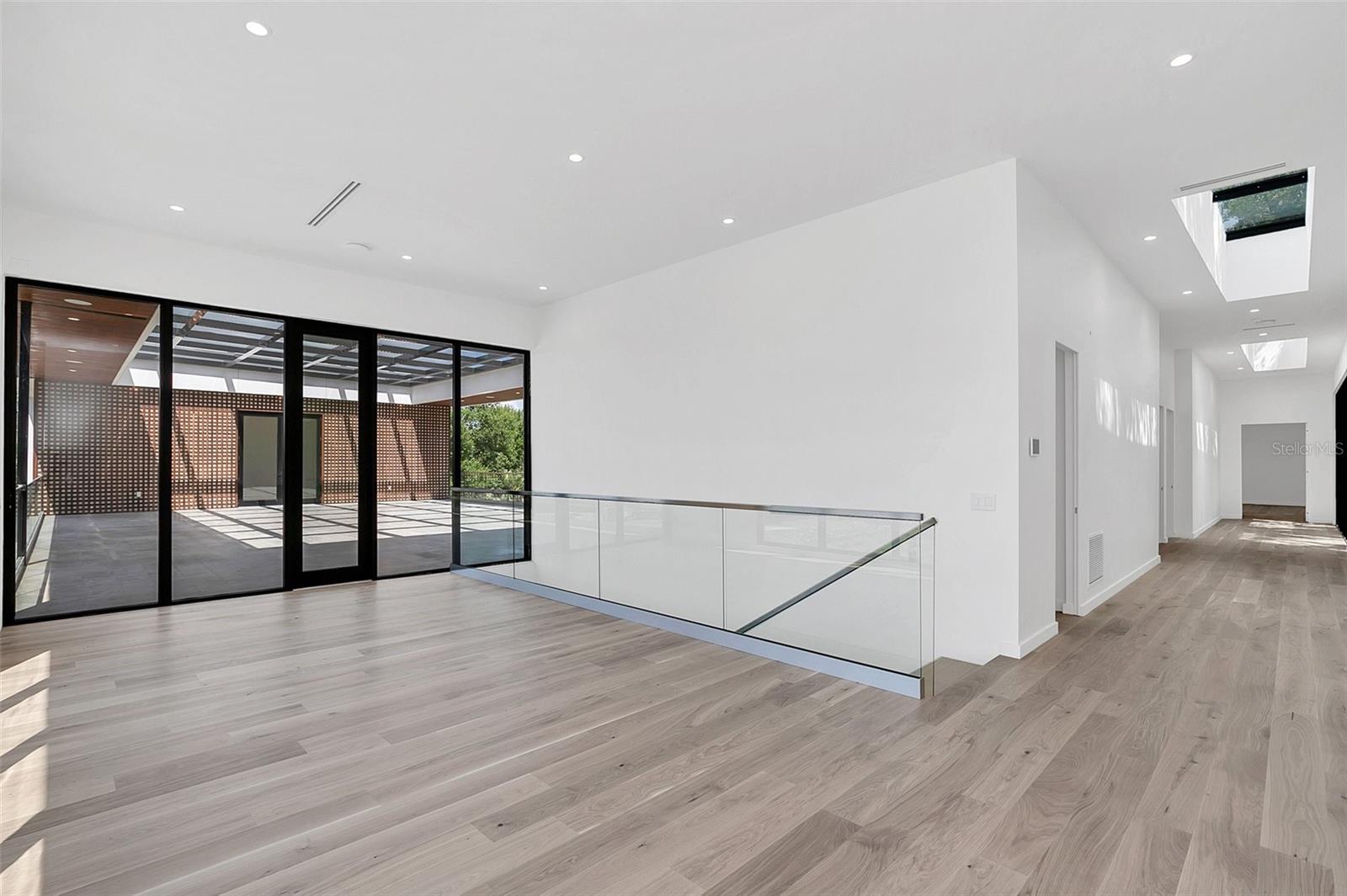 wide hallways with ultra high ceilings with sky lights 11835 Lake Butler Blvd, Windermere, FL 34786