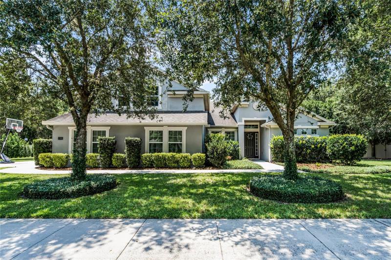 FRONT OF HOME: Beautiful Elevation, 3 Car-Side Garage, Mature Lush Landscape