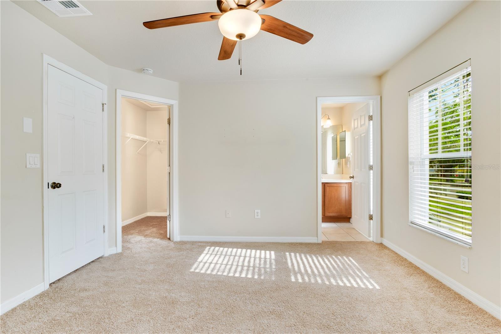 master bedroom with walk in closet and ensuite bathroom