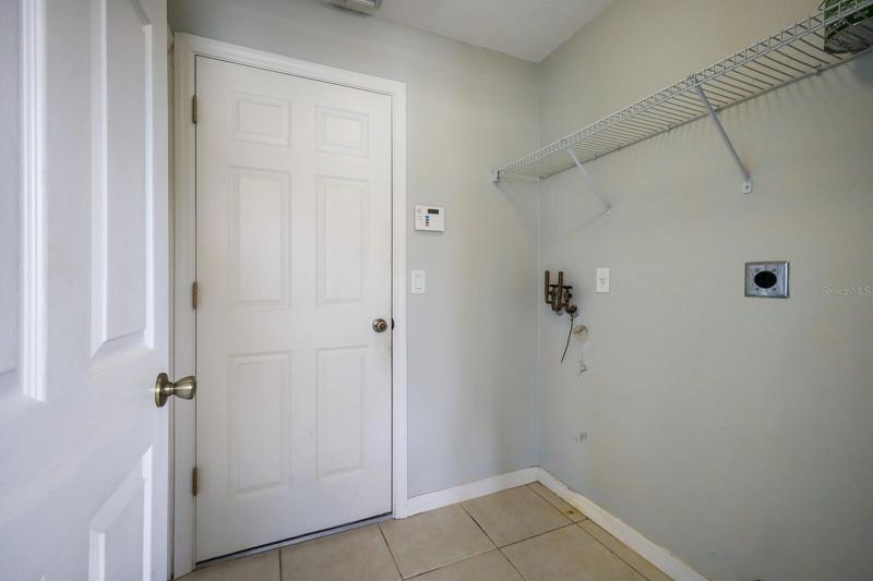 Interior laundry room with door leading out to the 2 car garage