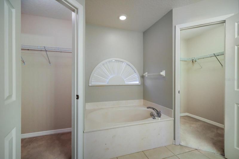 Two walk in closets in the primary bathroom
