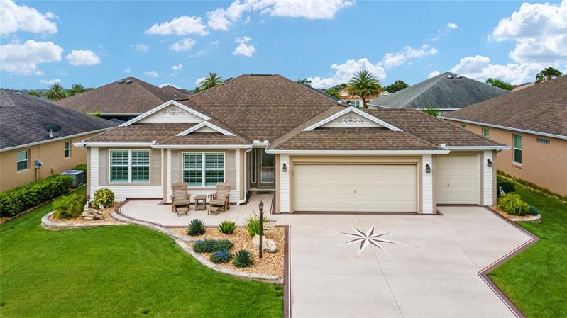 PICTURE PERFECT 3 BEDROOM 2 BATH WHISPERING PINE DESIGNER WITH CUSTOM PAINTED DRIVE AND WALKWAY AND ADDED FRONT PATIO!