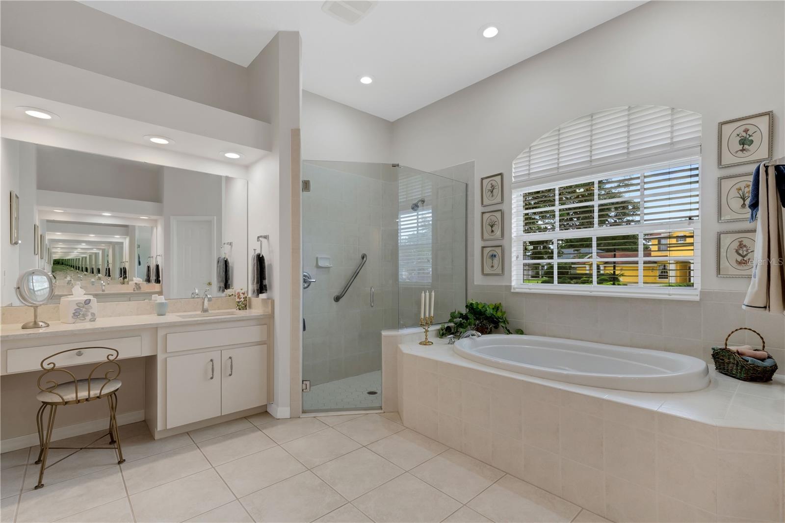 Large master bathroom with dual vanities, deep soaking tub and large tiled shower.